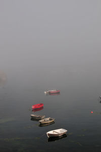 High angle view of boats in lake against sky