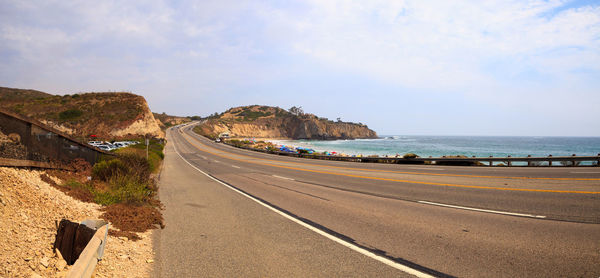 Road by sea against sky