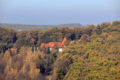 Panoramic view of trees and houses against sky during autumn