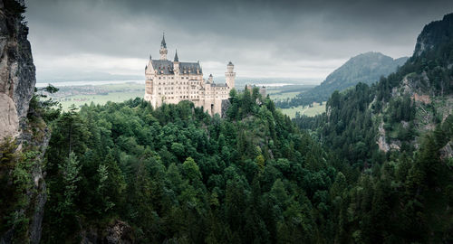 Panoramic view of trees and buildings against sky