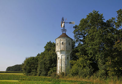 Water tower with pump wind turbine