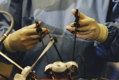 Midsection of surgeon operating in hospital