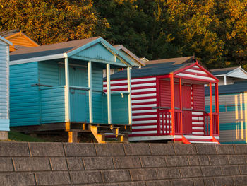 View of multi colored houses in park by building