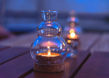 Close-up of illuminated tea light candles on table