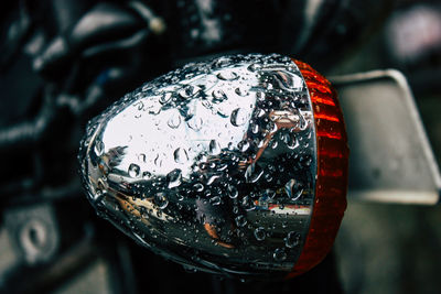 Close-up of wet headlight