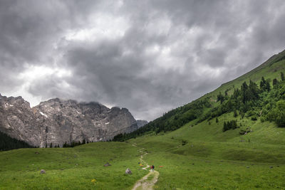 Scenic view of field and mountains against sky