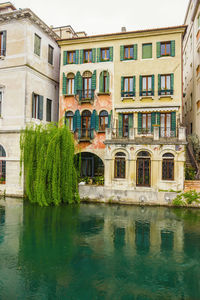 Reflection of building on canal in city