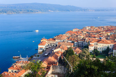 High angle view of townscape by sea against sky