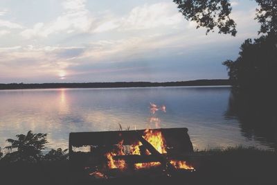 Scenic view of calm lake at sunset