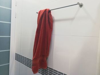 Close-up of clothes drying against white wall