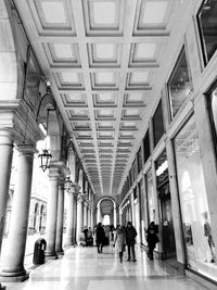 People walking in corridor of building