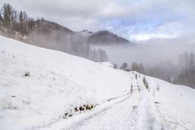 Scenic view of snow covered mountains against sky