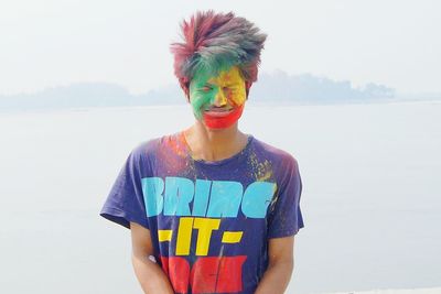 Man with multi colored face paint