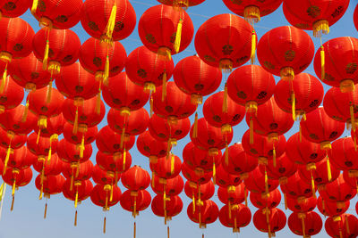 Low angle view of red lanterns hanging in row