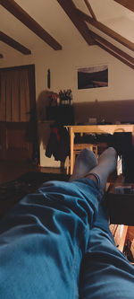 Low section of man relaxing on bed