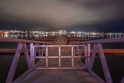 Illuminated bridge at night