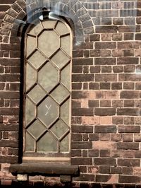 Full frame shot of window on brick wall of building