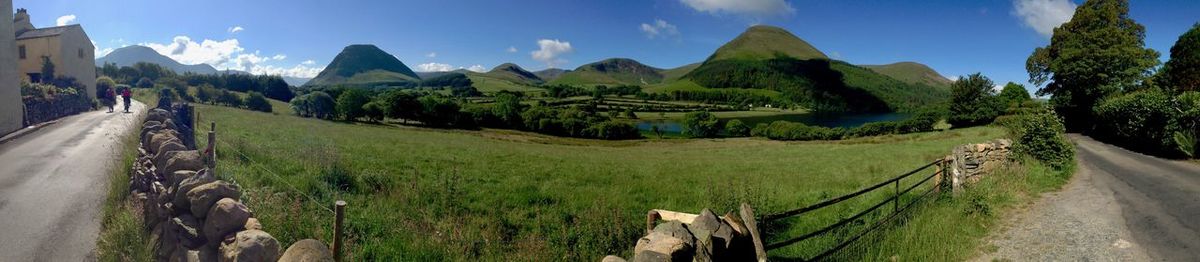 Panoramic view of green mountains against sky