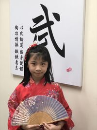 Portrait of young woman holding paper currency