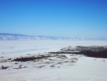 Scenic view of snowcapped mountains against clear blue sky