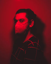 Close-up portrait of young man against wall