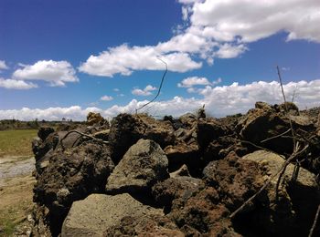 Close-up of rocks on beach against sky