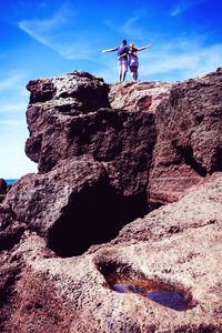 Low angle view of rock formation against sky