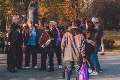 Group of people standing on sidewalk