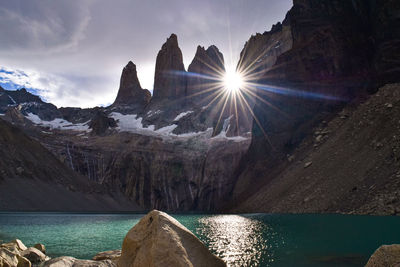 Scenic view of sea and mountains against sky