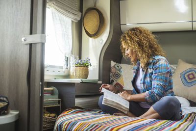 Portrait of smiling woman sitting on sofa at home