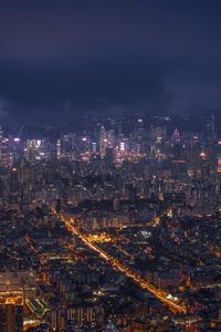 High angle view of illuminated buildings against sky at night