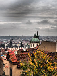 Cityscape against cloudy sky