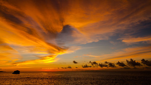 Scenic view of sea against romantic sky at sunset