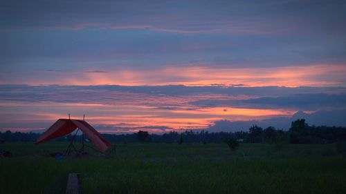 Scenic view of field against sky during sunset