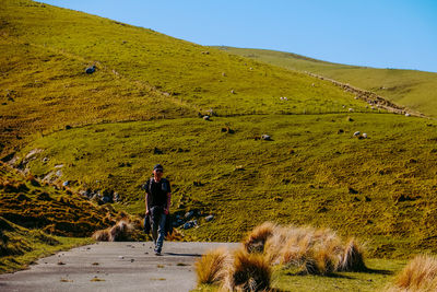 Full length of people walking on land against mountains