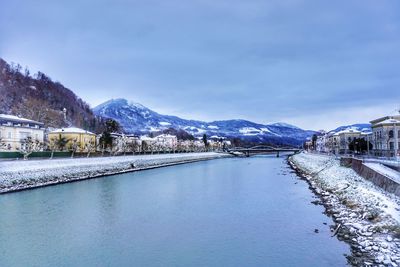 Scenic view of snowcapped mountains and lake against blue sky