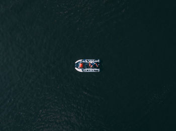 Directly above shot of man sitting in motorboat on sea