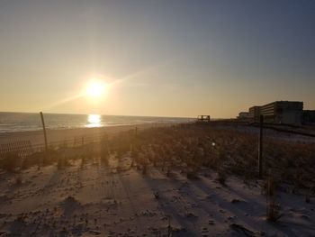 Scenic view of beach against sky during sunset