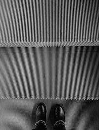 Low section of woman standing on tiled floor