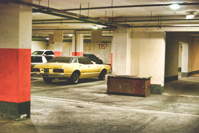 Cars parked in parking lot by building