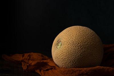 Close-up of cake on table against black background