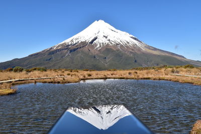 Scenic view of snowcapped mountains against clear blue sky