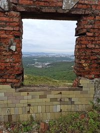 View of townscape against sky seen through window