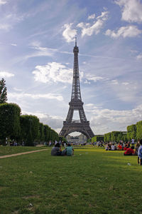 People relaxing in park near eiffel tower