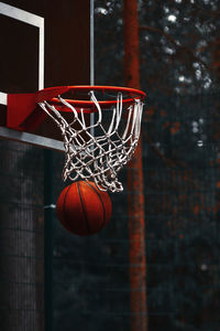 Close-up of ball below basketball hoop