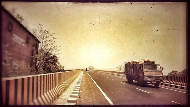 transportation, the way forward, transfer print, diminishing perspective, auto post production filter, vanishing point, mode of transport, road, road marking, land vehicle, sky, car, architecture, built structure, railroad track, no people, empty, building exterior, outdoors, street