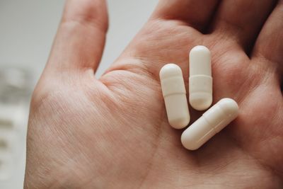 Close-up of human hand holding pills