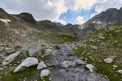 Scenic view of mountains against cloudy sky