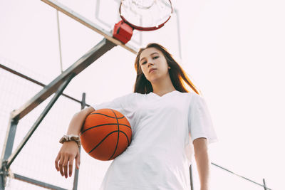 Portrait of young female basketball player. beautiful teen girl playing basketball.