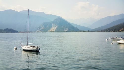 Boats sailing in sea against sky